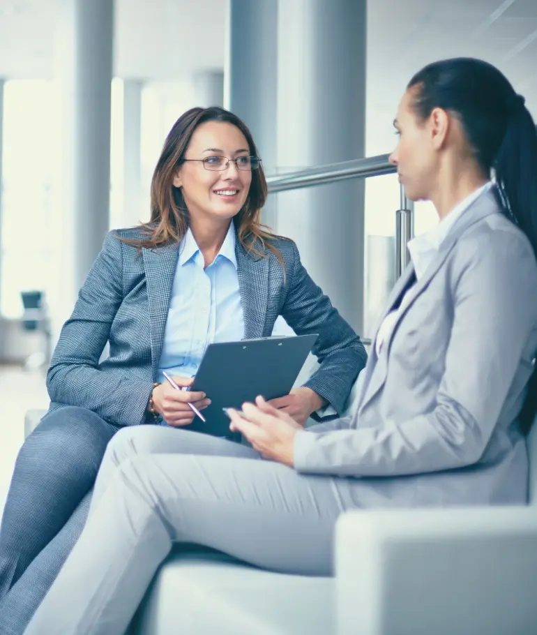 Two professionals discussing work in a modern office